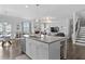 Open-concept kitchen features an island, stainless appliances, and seamless flow to the living area at 7630 Rambling Vale, Cumming, GA 30028
