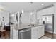 Open floor plan kitchen features stainless appliances, a large island, and seamless flow to living areas at 7630 Rambling Vale, Cumming, GA 30028