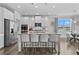 Bright kitchen with stainless steel appliances, a large island with seating and an adjacent dining area at 7630 Rambling Vale, Cumming, GA 30028