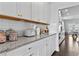 Kitchen featuring white cabinets, subway tile backsplash and granite countertops at 7630 Rambling Vale, Cumming, GA 30028