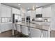Spacious kitchen with a granite island, stainless steel appliances, white cabinets, and pendant lighting at 7630 Rambling Vale, Cumming, GA 30028