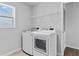 Bright laundry room with modern appliances and ample shelving for storage at 7630 Rambling Vale, Cumming, GA 30028