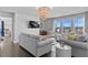 Stylish living room featuring plush seating, modern decor, and large windows that flood the space with natural light at 7630 Rambling Vale, Cumming, GA 30028