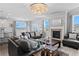 Open-concept living room with a fireplace, ample seating, and large windows for natural light at 7630 Rambling Vale, Cumming, GA 30028