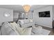 Upstairs living room with a modern chandelier and a TV at 7630 Rambling Vale, Cumming, GA 30028