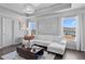 Bright living room with white sofa and coffered ceiling at 7630 Rambling Vale, Cumming, GA 30028