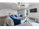 Open concept living room with contemporary sofas, a ceiling fan, and hardwood floors at 7630 Rambling Vale, Cumming, GA 30028