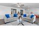 Inviting living room featuring modern sofas, sleek glass tables, and a ceiling fan at 7630 Rambling Vale, Cumming, GA 30028