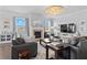 Inviting living room with a cozy brick fireplace, modern lighting, and stylish furnishings, ideal for relaxation and gatherings at 7630 Rambling Vale, Cumming, GA 30028