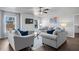 Cozy living room filled with natural light from the two large windows at 7630 Rambling Vale, Cumming, GA 30028