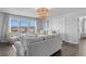 Inviting living room with neutral tones, a modern chandelier and plenty of seating at 7630 Rambling Vale, Cumming, GA 30028