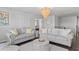 Comfortable living room features two sofas, a modern light fixture, and decor creating a welcoming atmosphere at 7630 Rambling Vale, Cumming, GA 30028