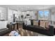 Open-concept living room with a modern kitchen, comfortable seating, and plenty of natural light at 7630 Rambling Vale, Cumming, GA 30028