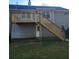 Backyard featuring a wooden deck with stairs leading to a grassy area and a two-story home with neutral siding at 153 Rockport Dr, Mcdonough, GA 30253