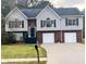 Charming two-story home with a brick and vinyl exterior, complemented by a well-manicured lawn and a two-car garage at 153 Rockport Dr, Mcdonough, GA 30253