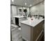Open kitchen featuring white cabinets, stainless steel appliances, quartz countertops and an island with seating and black dishwasher at 153 Rockport Dr, Mcdonough, GA 30253