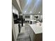 Open kitchen with granite countertops, a kitchen island, stainless steel appliances, and wood-look flooring at 153 Rockport Dr, Mcdonough, GA 30253