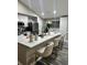 Open kitchen with granite countertops, stainless steel appliances, a large kitchen island, and barstool seating at 153 Rockport Dr, Mcdonough, GA 30253