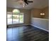 Bright living room featuring sleek, dark-stained hardwood flooring and a large window that offers plenty of natural light at 153 Rockport Dr, Mcdonough, GA 30253