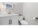 Bathroom featuring modern fixtures, a round mirror, and a pristine white vanity at 3140 Sawnee Lake Trl, Cumming, GA 30040