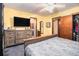 Bright bedroom with yellow walls, dresser, and patterned bedding at 5843 Foxfield Trl, Rex, GA 30273