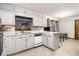 Open kitchen with white cabinets, stainless steel appliances, and adjacent dining area at 5843 Foxfield Trl, Rex, GA 30273