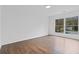 Bedroom with hardwood floors and a large window providing lots of natural light at 935 Tiber Cir, Alpharetta, GA 30022