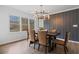 Dining room featuring a modern chandelier, accent wall, and large windows providing natural light at 935 Tiber Cir, Alpharetta, GA 30022
