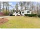 Exterior elevation featuring well-maintained lawn, garage, and mature trees at 935 Tiber Cir, Alpharetta, GA 30022