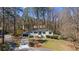 Aerial view of a single story home with mature trees, landscaping and driveway at 935 Tiber Cir, Alpharetta, GA 30022