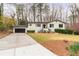 Inviting single-story home with garage, well-manicured lawn, and blooming spring flowers at 935 Tiber Cir, Alpharetta, GA 30022