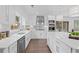 Updated kitchen with white cabinets, stainless appliances, an island with breakfast bar, and plenty of natural light at 935 Tiber Cir, Alpharetta, GA 30022