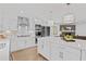 Modern kitchen with white cabinets, stainless steel appliances, and a large island with white countertop at 935 Tiber Cir, Alpharetta, GA 30022