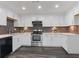 Modern kitchen featuring quartz counters, stainless steel appliances, and custom backsplash at 935 Tiber Cir, Alpharetta, GA 30022
