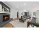 Cozy living room with a fireplace, modern decor, and hardwood flooring at 935 Tiber Cir, Alpharetta, GA 30022
