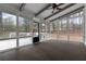 Bright sunroom boasts natural light with large windows and a ceiling fan at 935 Tiber Cir, Alpharetta, GA 30022