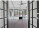 Enclosed sunroom with tiled floor and ceiling fan leading to a cozy backyard at 935 Tiber Cir, Alpharetta, GA 30022