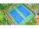 Aerial view of the community tennis courts surrounded by trees and shrubs at 1507 Country Park Se Dr, Smyrna, GA 30080