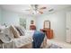 Comfortable bedroom with dresser, desk and cozy bed featuring a blue throw at 1507 Country Park Se Dr, Smyrna, GA 30080