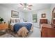 Bright bedroom featuring a cozy bed with a blue throw blanket, dresser, and desk at 1507 Country Park Se Dr, Smyrna, GA 30080