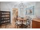 Dining room with a wood table, decorative chandelier, hutch, display case, and wood floors at 1507 Country Park Se Dr, Smyrna, GA 30080