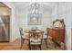 Dining room with a wood table, decorative chandelier, mirror and wooden floors at 1507 Country Park Se Dr, Smyrna, GA 30080