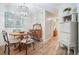 Dining room with a wood table, decorative chandelier, hutch, display case, and wood floors at 1507 Country Park Se Dr, Smyrna, GA 30080