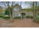 Two-story home with balconies, surrounded by mature trees and autumnal foliage at 1507 Country Park Se Dr, Smyrna, GA 30080