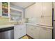 Bright kitchen featuring white cabinets, stainless steel dishwasher, and modern countertops at 1507 Country Park Se Dr, Smyrna, GA 30080