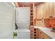 Bright laundry room features a stackable washer and dryer next to storage cabinets and a light countertop at 1507 Country Park Se Dr, Smyrna, GA 30080