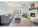 Inviting living room featuring a fireplace, hardwood floors, and abundant natural light at 1507 Country Park Se Dr, Smyrna, GA 30080