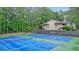 Community tennis courts with blue playing surface next to a building and lush trees at 1507 Country Park Se Dr, Smyrna, GA 30080