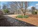 Expansive backyard featuring a stone pathway, mature trees, and a well-maintained lawn at 4010 Arborwood Ln, Tucker, GA 30084