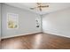 Spacious bedroom with hardwood floors, a ceiling fan, and large windows at 4010 Arborwood Ln, Tucker, GA 30084